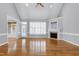 Spacious living room with vaulted ceilings, hardwood floors, and a cozy fireplace at 4005 Olde Waverly Way, Fuquay Varina, NC 27526