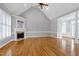 Spacious living room with vaulted ceilings, hardwood floors, and a cozy fireplace at 4005 Olde Waverly Way, Fuquay Varina, NC 27526