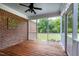 Relaxing screened porch with brick accent wall, ceiling fan, and wood flooring at 4005 Olde Waverly Way, Fuquay Varina, NC 27526
