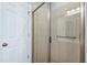 This bathroom has a glass door shower with tile walls, and a handrail at 4005 Olde Waverly Way, Fuquay Varina, NC 27526