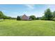 Expansive, well-manicured lawn surrounds a beautiful home, showcasing the property's curb appeal and spaciousness at 4005 Olde Waverly Way, Fuquay Varina, NC 27526