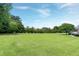 Lush yard with trees, landscaping, and a well-maintained lawn at 4005 Olde Waverly Way, Fuquay Varina, NC 27526