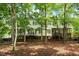 Back of a large home with multi-level decks surrounded by mature trees at 405 Commons Walk Cir, Cary, NC 27519