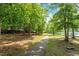 Scenic walking path through the backyard, leading to a tranquil lake at 405 Commons Walk Cir, Cary, NC 27519