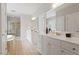 Bathroom featuring tile floors, double vanity with mirrors, bathtub, and glass door shower at 405 Commons Walk Cir, Cary, NC 27519