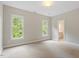 Bright bedroom with carpet floors and view to outdoor landscape at 405 Commons Walk Cir, Cary, NC 27519