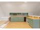 Unique bonus room with custom cabinetry, wood floors, and plenty of workspace at 405 Commons Walk Cir, Cary, NC 27519