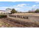Community sign at Carpenter Village surrounded by beautiful landscaping and well-maintained greenery at 405 Commons Walk Cir, Cary, NC 27519