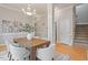 Dining room featuring hardwood floors, a modern chandelier, and stylish seating at 405 Commons Walk Cir, Cary, NC 27519