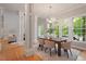 Dining room features hardwood floors, bright windows, and stylish furniture at 405 Commons Walk Cir, Cary, NC 27519