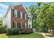 Charming brick home with black shutters and manicured landscaping at 405 Commons Walk Cir, Cary, NC 27519