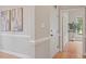 Bright hallway featuring elegant trim work and hardwood floors at 405 Commons Walk Cir, Cary, NC 27519