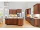 Open kitchen features wood cabinets, granite counters, stainless appliances and hardwood floors at 405 Commons Walk Cir, Cary, NC 27519