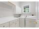 Laundry room with white cabinets, folding counter and window at 405 Commons Walk Cir, Cary, NC 27519