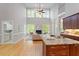 Open floor plan with hardwood floors and kitchen view to a fireplace and lots of natural light at 405 Commons Walk Cir, Cary, NC 27519