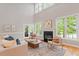 Spacious living room with fireplace, comfortable seating, and natural light at 405 Commons Walk Cir, Cary, NC 27519