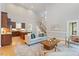 Open-concept living room with hardwood floors, a fireplace, and abundant light at 405 Commons Walk Cir, Cary, NC 27519