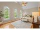 Serene main bedroom with vaulted ceilings, ample natural light, and elegant furnishings at 405 Commons Walk Cir, Cary, NC 27519