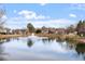 Scenic pond featuring a fountain and surrounded by lush landscaping and residential properties at 405 Commons Walk Cir, Cary, NC 27519