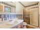 Neutral bathroom with a single vanity, matching medicine cabinet, and glass enclosed shower at 462 Sullivan Rd, Selma, NC 27576