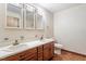 Bathroom with double vanity, medicine cabinets, wood cabinets, and tiled floor at 462 Sullivan Rd, Selma, NC 27576