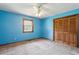 Bedroom with blue walls, carpet, a ceiling fan, and a wooden closet at 462 Sullivan Rd, Selma, NC 27576