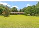 Spacious front yard with mature trees surrounding the brick home at 462 Sullivan Rd, Selma, NC 27576