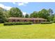 Well-maintained brick home with mature landscaping and large, green front yard at 462 Sullivan Rd, Selma, NC 27576