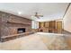 Bright living room with brick fireplace and custom shelving at 462 Sullivan Rd, Selma, NC 27576