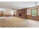 Spacious living room features a brick fireplace and wood paneling at 462 Sullivan Rd, Selma, NC 27576