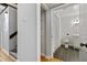Hallway featuring coat closet and entry to a modern bathroom with a tile floor and neutral-colored decor at 500 N Duke St # 55-105, Durham, NC 27701