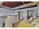 Modern bedroom with exposed wood ceiling, two open closets, and a comfortable bed with plush bedding at 500 N Duke St # 55-105, Durham, NC 27701
