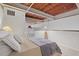 Bedroom with exposed wood ceiling, neutral carpet, and ladder to loft, offering a modern aesthetic at 500 N Duke St # 55-105, Durham, NC 27701