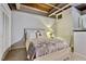 Cozy bedroom features exposed wood ceiling, carpeted floors, and a comfortable bed with decorative pillows at 500 N Duke St # 55-105, Durham, NC 27701