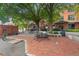 Community courtyard with brick pavers, outdoor furniture, mature shade trees, and convenient bike parking at 500 N Duke St # 55-105, Durham, NC 27701