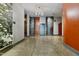 Bright hallway with architectural metal doors, polished concrete floors, modern light fixtures, and a blue accent wall at 500 N Duke St # 55-105, Durham, NC 27701