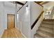 Well-lit hallway with wood floors and a carpeted staircase leading to the upper level of the home at 500 N Duke St # 55-105, Durham, NC 27701