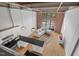 Modern living room featuring exposed ceilings, oversized windows, and a stylish kitchen area at 500 N Duke St # 55-105, Durham, NC 27701