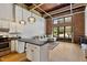 Inviting living space with exposed brick, hardwood floors, and an open layout connected to the kitchen at 500 N Duke St # 55-105, Durham, NC 27701
