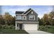 Charming two-story home featuring gray siding, a two-car garage, and meticulously landscaped front yard at 537 Morning Light Dr, Angier, NC 27501