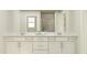 Well-lit bathroom features a double vanity and ample storage space at 544 Morning Light Dr, Angier, NC 27501