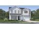 Charming two-story home with gray and white siding, stone accents, and a well-manicured lawn at 544 Morning Light Dr, Angier, NC 27501