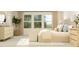 Bright bedroom featuring large windows, a neutral color palette, and modern furnishings at 549 Morning Light Dr, Angier, NC 27501