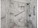 Elegant marble bathroom featuring a spacious shower with grab bars and a built-in niche at 6 Danesfield Ct, Durham, NC 27707