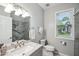 Bathroom with vanity, toilet, and shower/tub combo near a window at 6 Danesfield Ct, Durham, NC 27707
