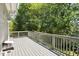 A spacious backyard deck is perfect for outdoor relaxation and entertaining with ample sunlight and views of mature trees at 6 Danesfield Ct, Durham, NC 27707