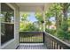 A view from the covered deck showing a charming birdhouse and the tranquil backyard at 6 Danesfield Ct, Durham, NC 27707