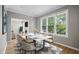 Bright dining room featuring a modern table set and view of the living room at 6 Danesfield Ct, Durham, NC 27707