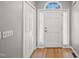 Bright entryway featuring a white door, hardwood floors, side-light windows and closet at 6 Danesfield Ct, Durham, NC 27707