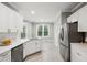 Bright kitchen with stainless steel appliances, marble countertops, and tile flooring at 6 Danesfield Ct, Durham, NC 27707